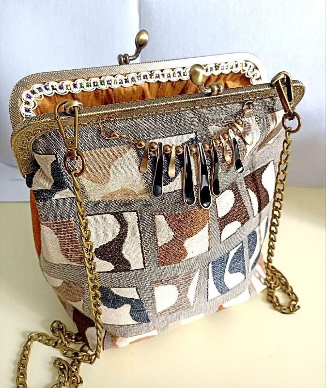 Stylish handmade handbag with a metal clasp and a long chain. - Atelier Lusi